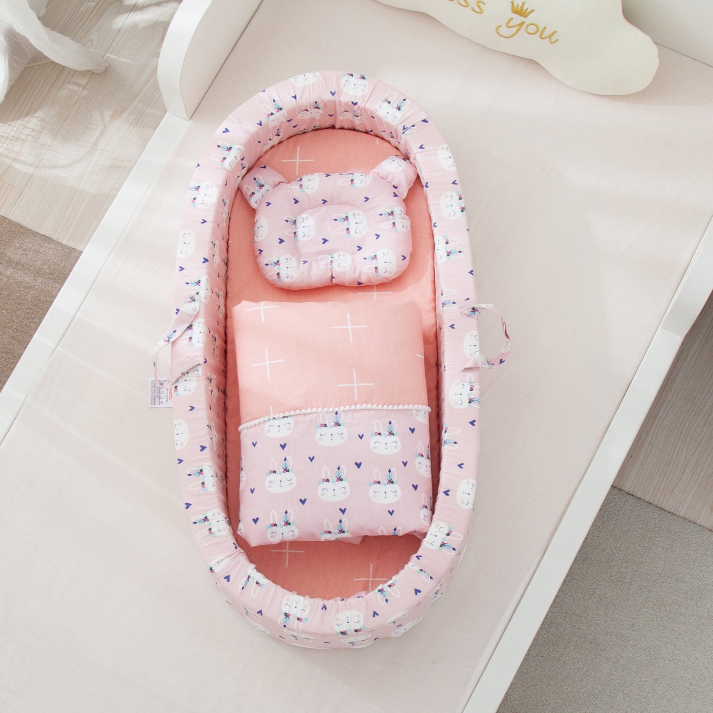 Pink baby nest with bunny rabbit