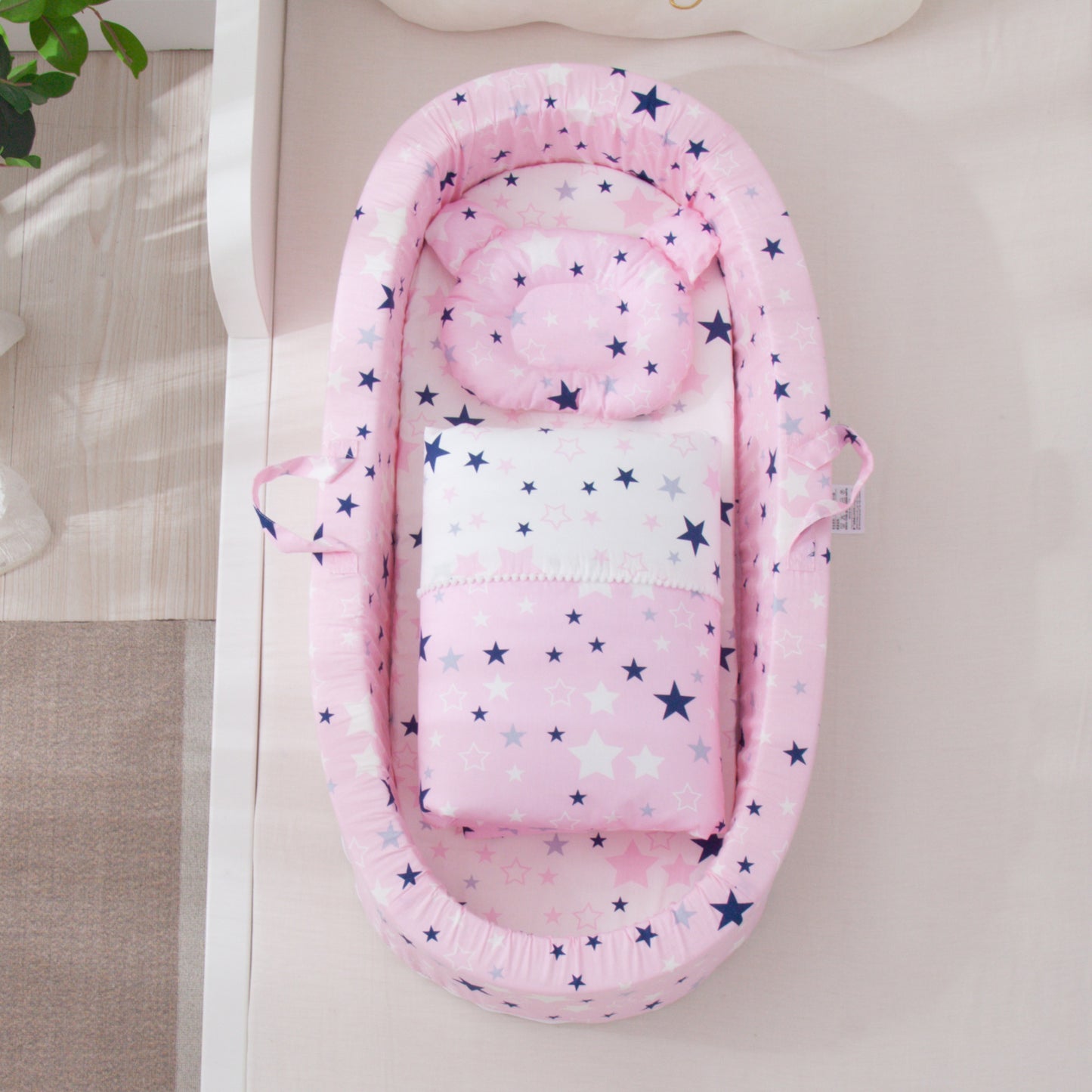 Pink baby nest with star pattern