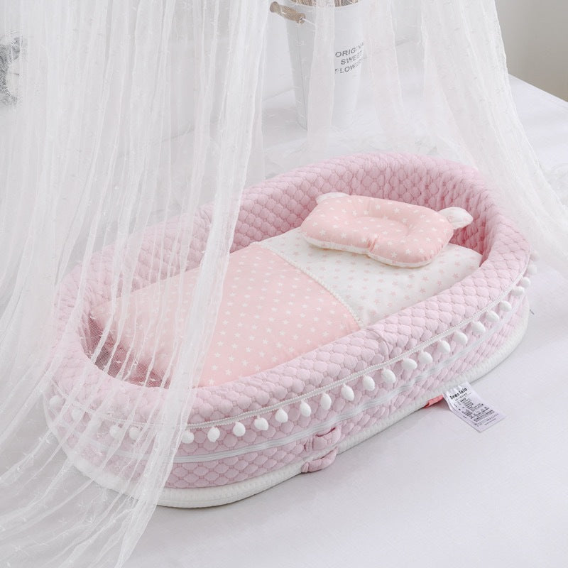 Pink baby crib with canopy on a white background