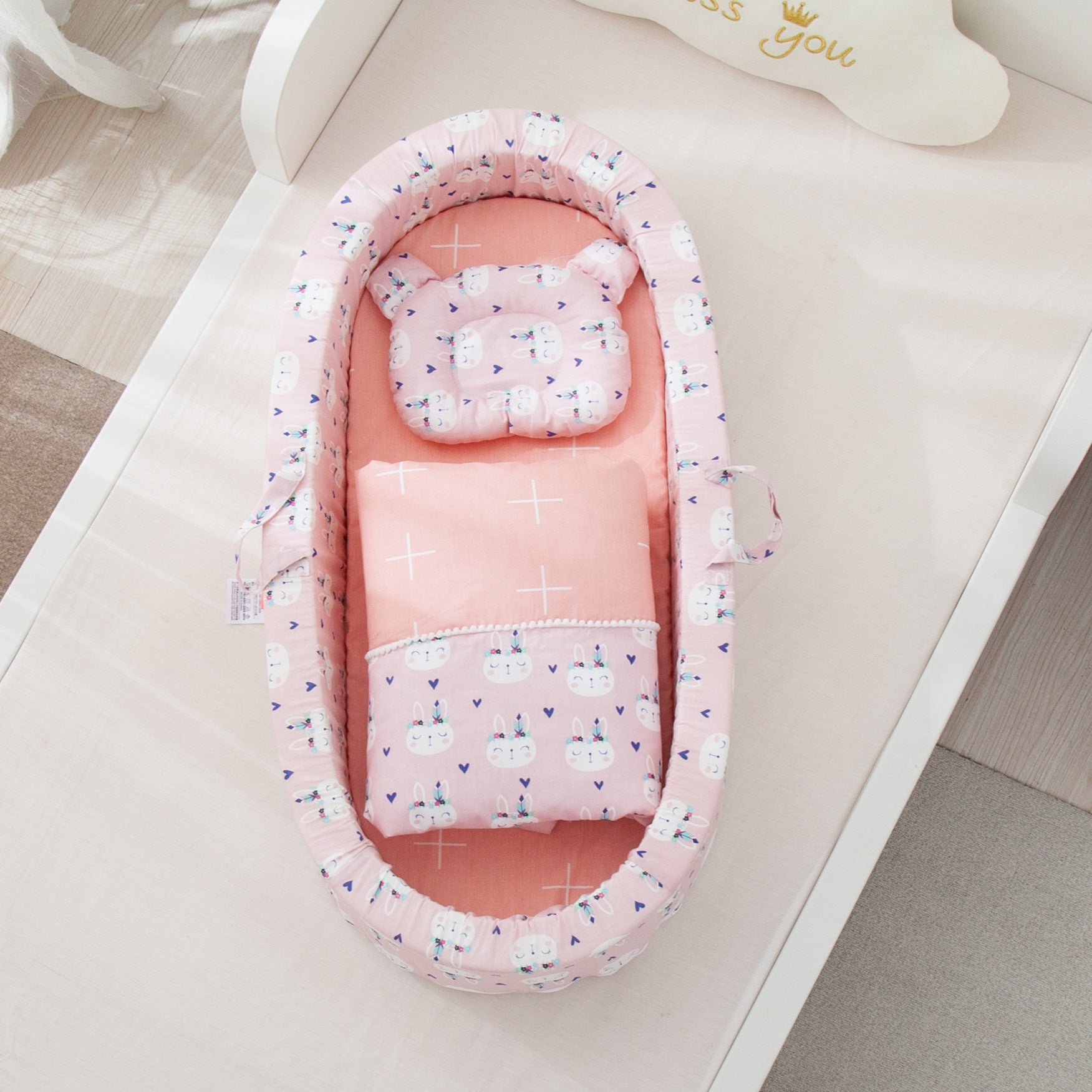 Pink baby nest with bunny rabbit